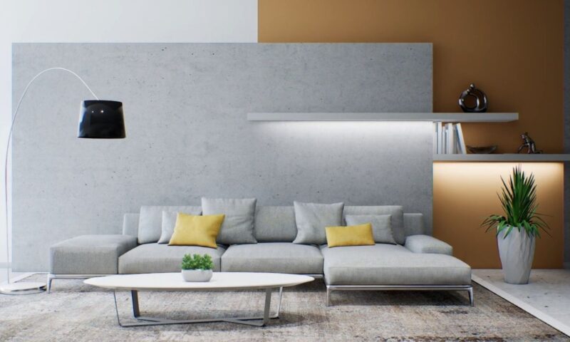 prikaz sivo krem zida u dnevnom boravku sa sivom ugaonom i velikom lapom kao i led svetlom, stolčićem i tepihom